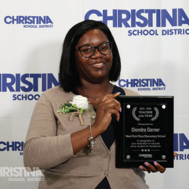 Photo of Diondra Garner West Park Place Teacher of the Year holding plaque